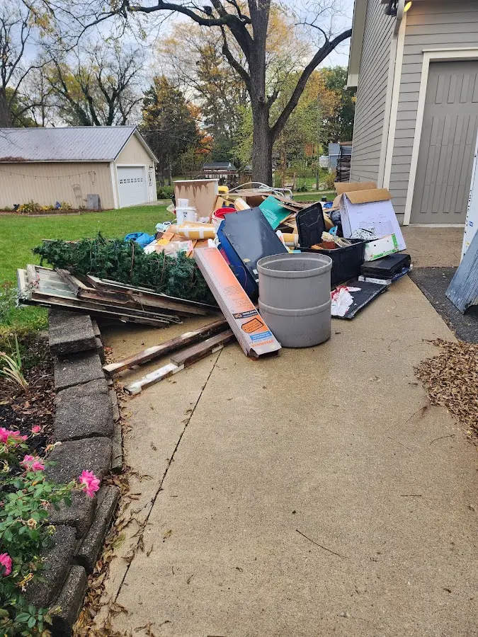 Dumpster being loaded with debris for 3 Yard Dumpster Rental in Needville
